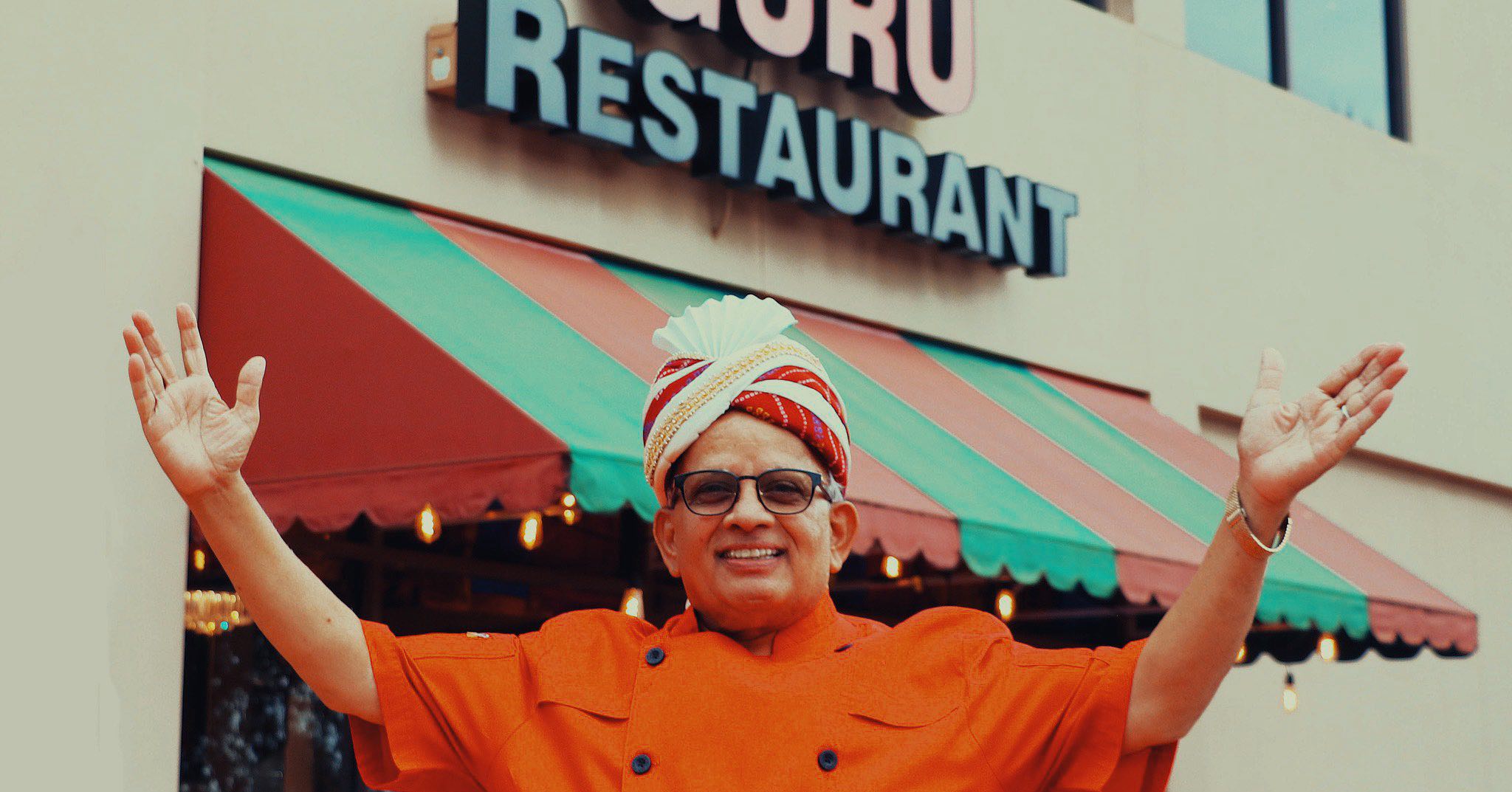 Guru Indian Restaurant's Chef and Owner Uday Kadam posing in front of Guru Indian Restaurant
